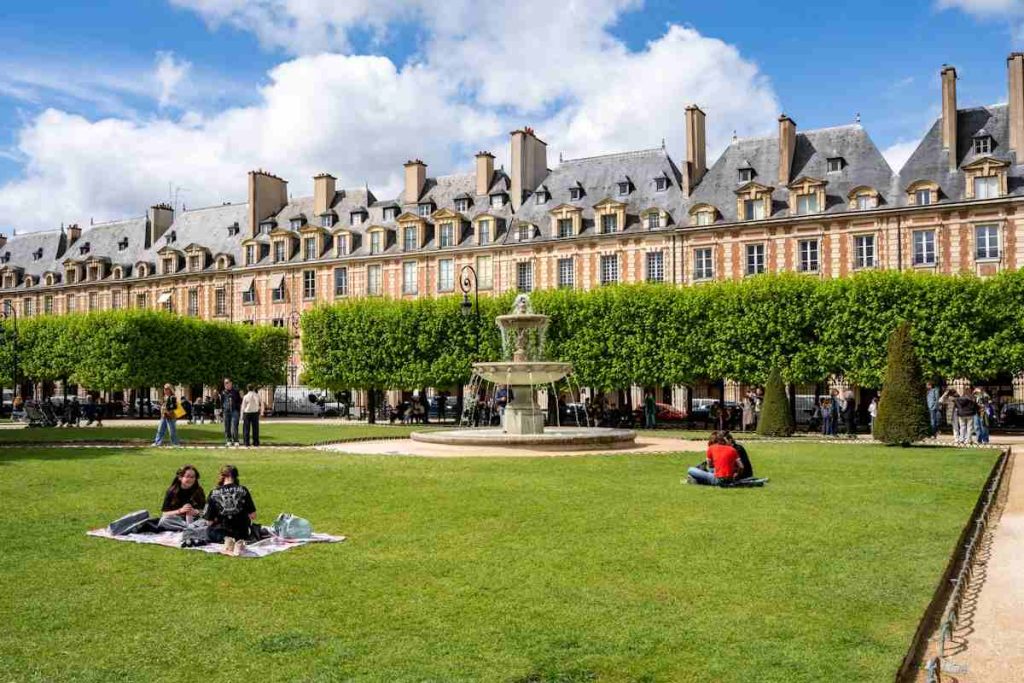 People relax in the green space of a park.